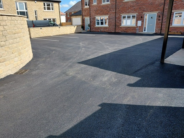 Bay marked tarmac parking area on a residential development