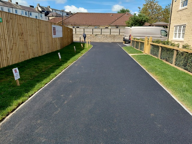 New tarmac access road and driveway on a residential development