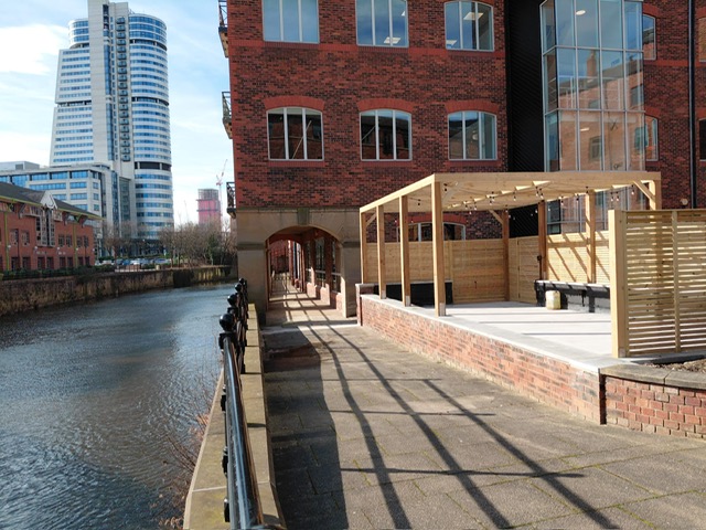Paved waterside terrace beside the river in central Leeds