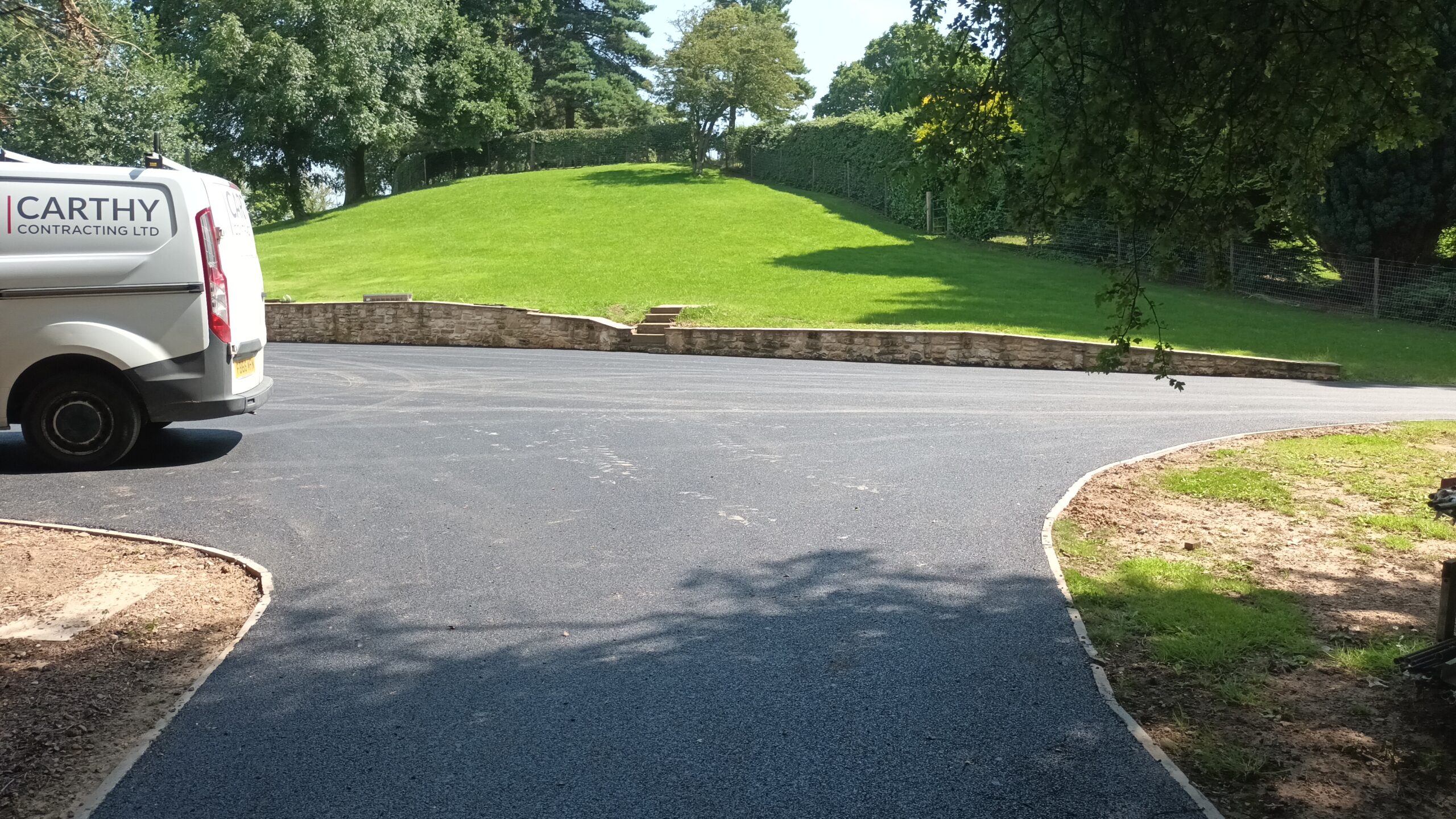Large sweeping tarmac private driveway with a Carthy Contracting van