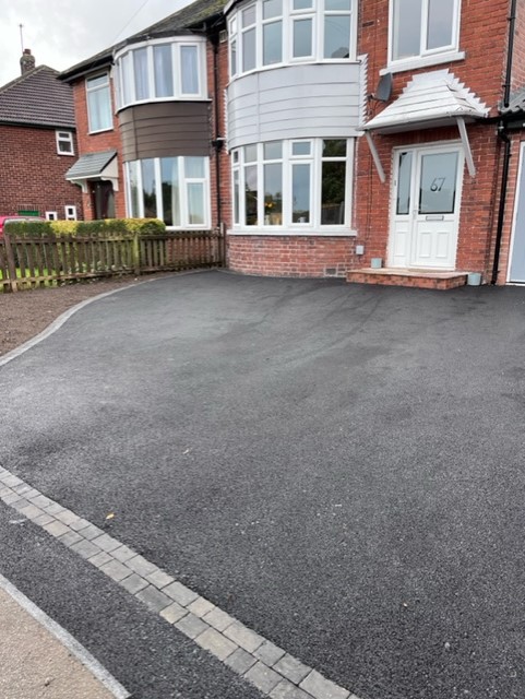 Tarmac driveway with block paved edge course at a semi detached house